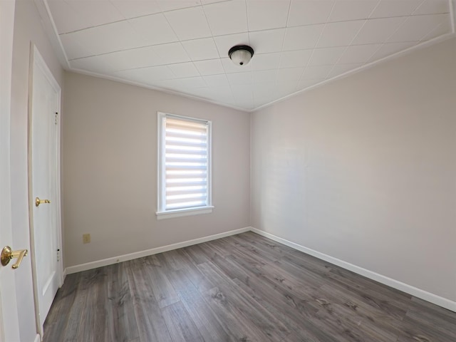 empty room featuring baseboards and dark wood-style flooring