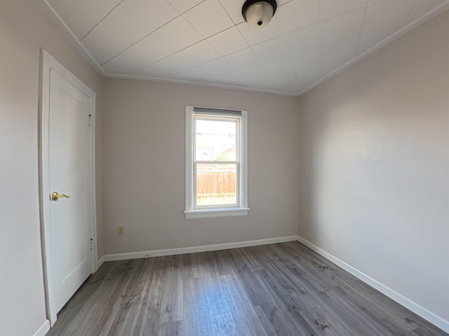 empty room with baseboards and wood finished floors