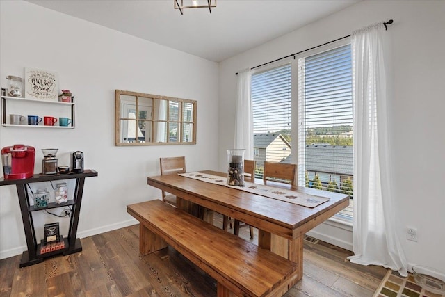 dining room with baseboards and dark wood-style flooring