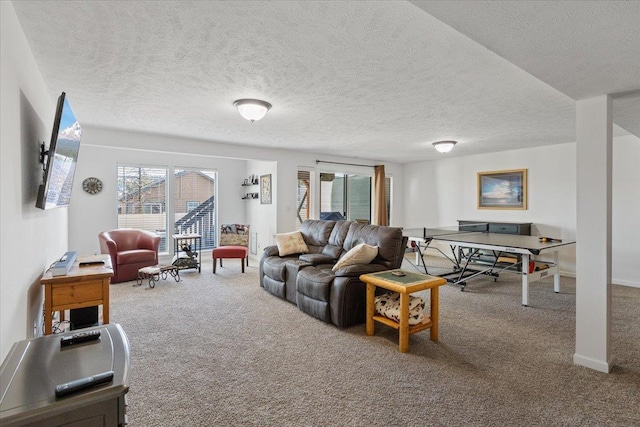 living room featuring a healthy amount of sunlight, a textured ceiling, and carpet