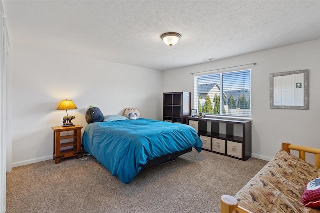 bedroom with baseboards, visible vents, a textured ceiling, and carpet