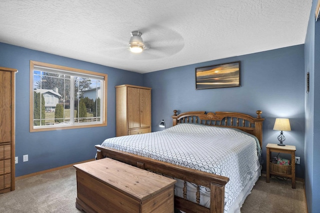 carpeted bedroom featuring baseboards, a textured ceiling, and ceiling fan