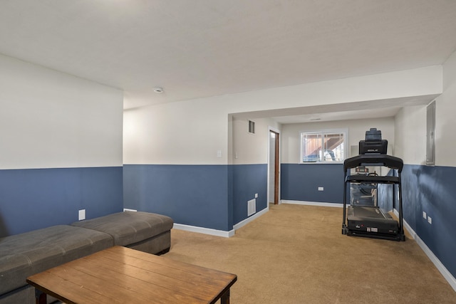 exercise area featuring carpet and baseboards