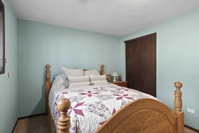 carpeted bedroom with baseboards, a closet, and a textured ceiling