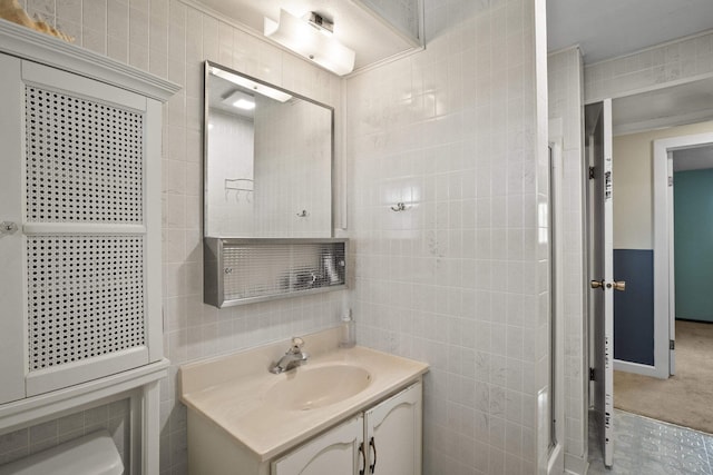 bathroom with vanity and tile walls