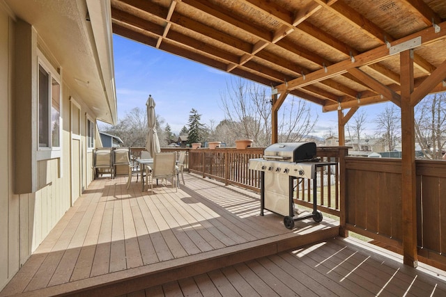 wooden terrace with area for grilling and outdoor dining area