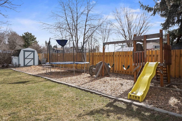 view of play area featuring a storage unit, an outbuilding, a lawn, a trampoline, and a fenced backyard