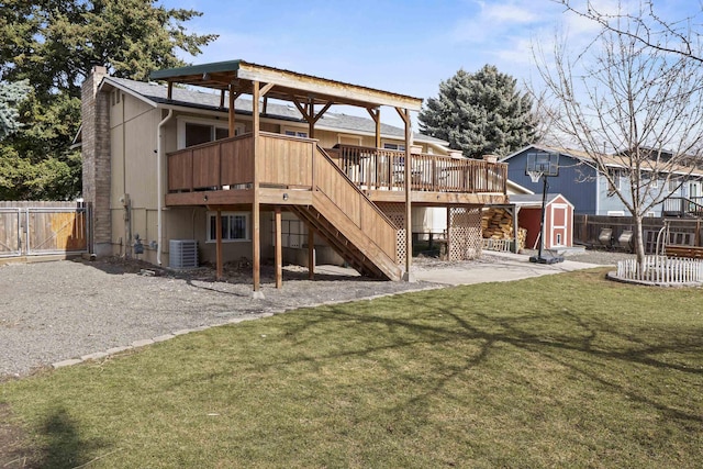 rear view of property with an outdoor structure, central air condition unit, fence, and a shed