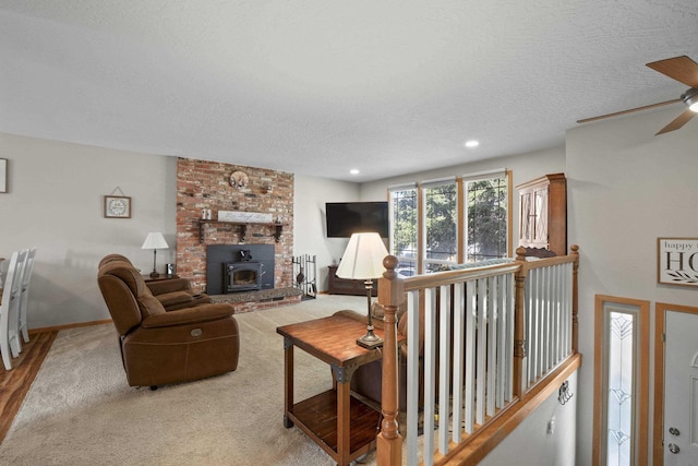 carpeted living area featuring recessed lighting, baseboards, a textured ceiling, and a ceiling fan