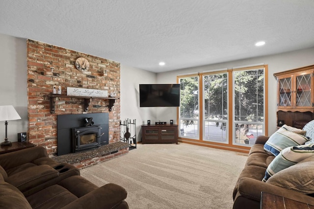 carpeted living area with recessed lighting and a textured ceiling