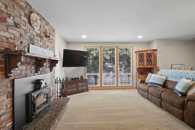 carpeted living room with recessed lighting and a textured ceiling