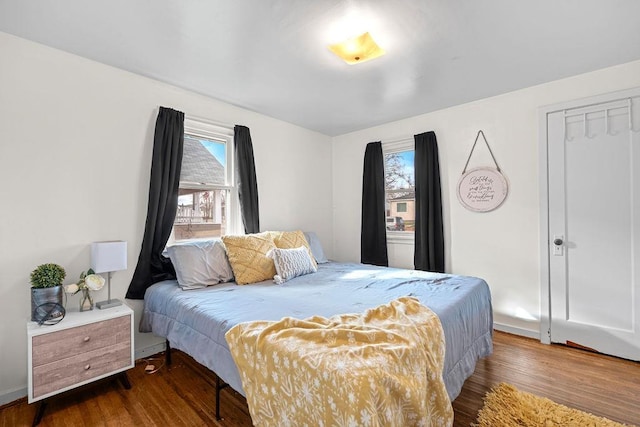 bedroom featuring multiple windows and wood finished floors