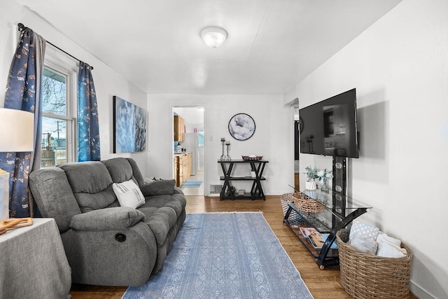 living area featuring baseboards and wood finished floors