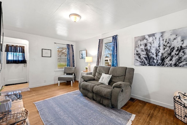 living room featuring baseboards and wood finished floors