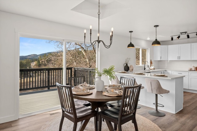 6712 C Highway 291, Nine Mile Falls, WA 99026 - dining space with light wood-type flooring and a mountain view