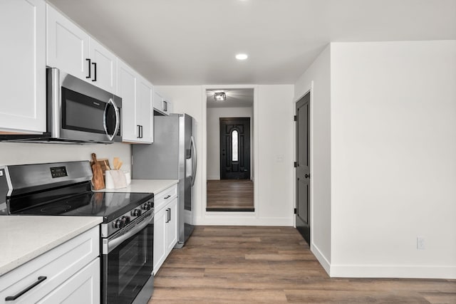 6712 C Highway 291, Nine Mile Falls, WA 99026 - kitchen with appliances with stainless steel finishes, wood finished floors, white cabinets, recessed lighting, and baseboards
