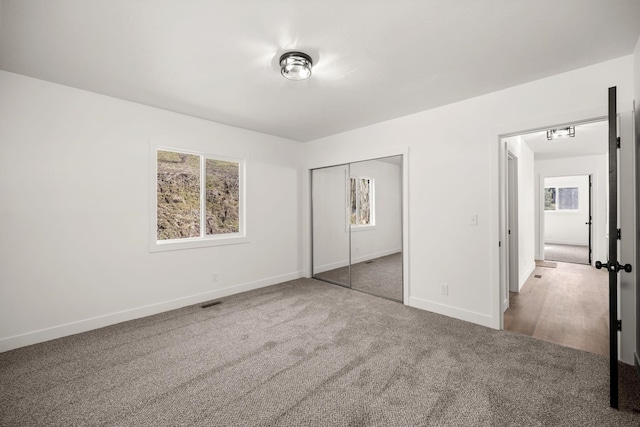 6712 C Highway 291, Nine Mile Falls, WA 99026 - unfurnished bedroom featuring carpet floors, baseboards, and a closet