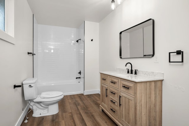 6712 C Highway 291, Nine Mile Falls, WA 99026 - full bathroom featuring toilet, wood finished floors, vanity, baseboards, and shower / bathtub combination