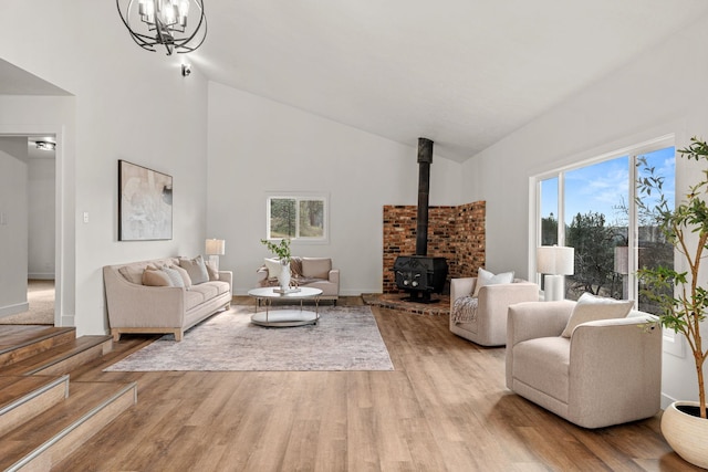 6712 C Highway 291, Nine Mile Falls, WA 99026 - living area with high vaulted ceiling, healthy amount of natural light, a wood stove, and wood finished floors