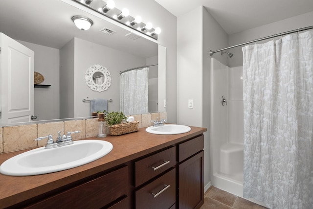 full bath with tile patterned floors, a shower with curtain, and a sink