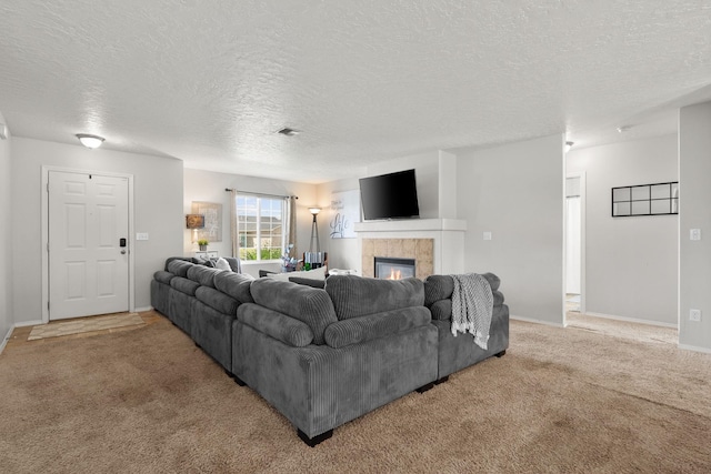 living room featuring visible vents, light carpet, baseboards, and a tiled fireplace