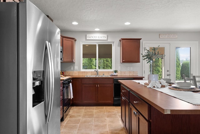 kitchen with recessed lighting, a textured ceiling, black appliances, and a sink