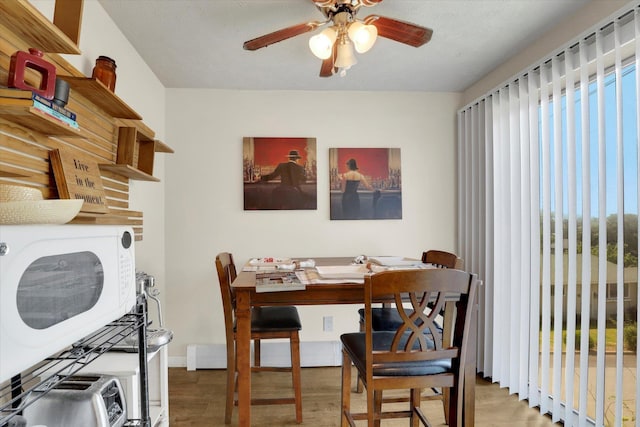 12017 E Mansfield Avenue ., Spokane Valley, WA 99206 - dining room featuring wood finished floors, baseboards, plenty of natural light, and ceiling fan