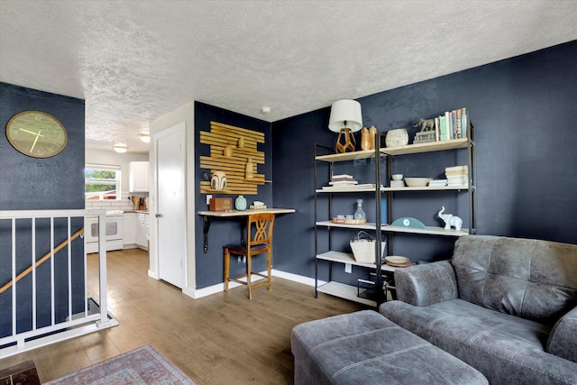12017 E Mansfield Avenue ., Spokane Valley, WA 99206 - living area featuring wood finished floors, baseboards, and a textured ceiling