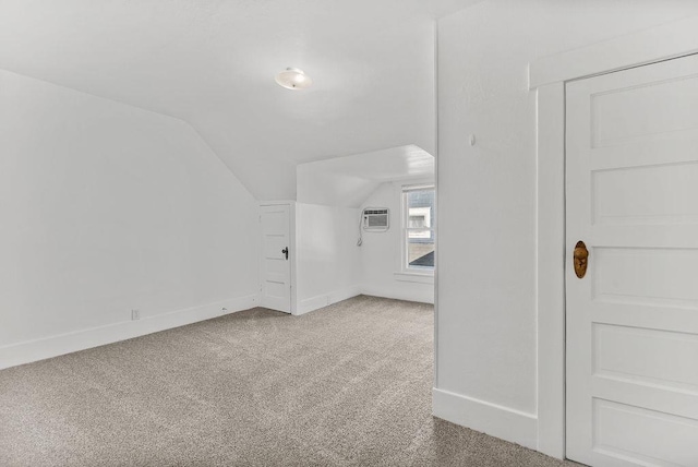 bonus room featuring lofted ceiling, baseboards, carpet floors, and a wall mounted air conditioner