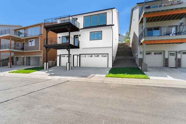 806 W Bolan Ave, Spokane, WA 99224 - view of front facade featuring a garage, board and batten siding, and driveway