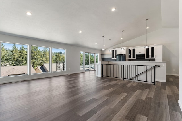 806 W Bolan Ave, Spokane, WA 99224 - unfurnished living room featuring dark wood-style flooring, baseboards, recessed lighting, and high vaulted ceiling