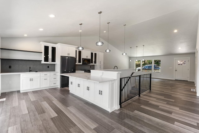 806 W Bolan Ave, Spokane, WA 99224 - kitchen featuring freestanding refrigerator, wood finished floors, white cabinetry, light countertops, and tasteful backsplash