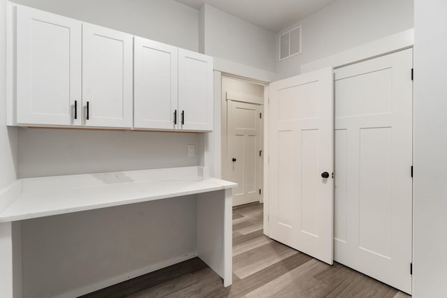 806 W Bolan Ave, Spokane, WA 99224 - kitchen featuring wood finished floors and white cabinetry