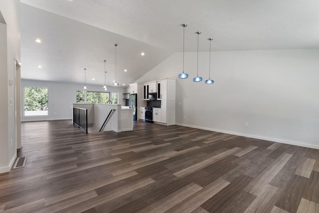 806 W Bolan Ave, Spokane, WA 99224 - kitchen with open floor plan, stainless steel microwave, white cabinetry, an island with sink, and black gas range