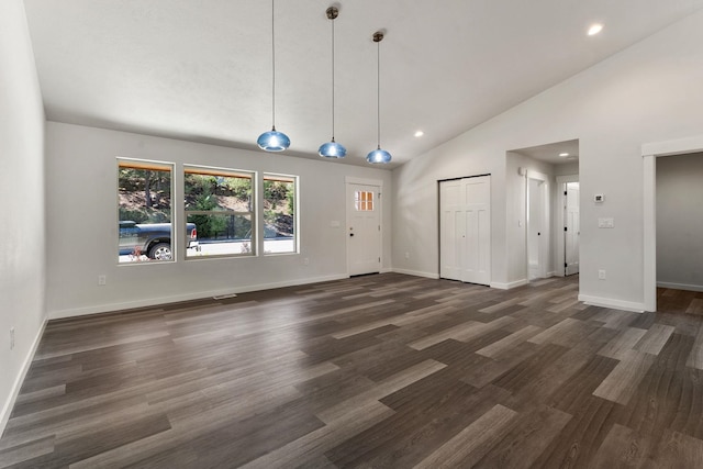 806 W Bolan Ave, Spokane, WA 99224 - unfurnished living room with vaulted ceiling, recessed lighting, dark wood-type flooring, and baseboards