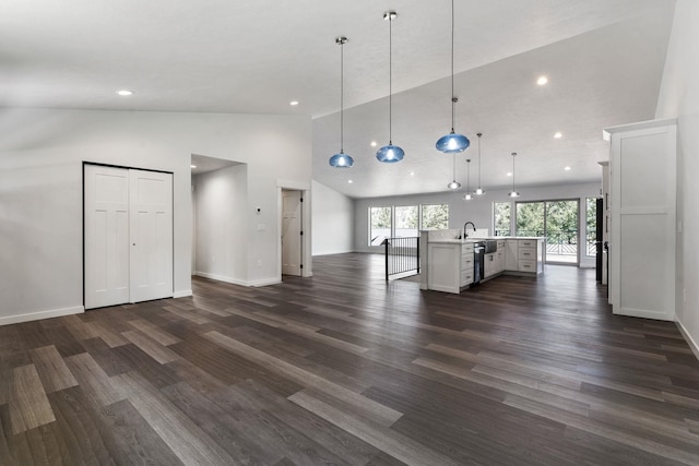806 W Bolan Ave, Spokane, WA 99224 - unfurnished living room featuring vaulted ceiling, dark wood finished floors, recessed lighting, baseboards, and a sink