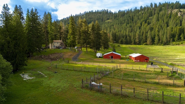 2063-A Marble Valley Basin Rd, Addy, WA 99101 - view of home's community with a view of countryside, a pole building, a view of trees, and an outdoor structure