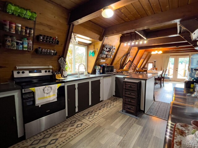 2063-A Marble Valley Basin Rd, Addy, WA 99101 - kitchen featuring appliances with stainless steel finishes, wooden walls, a peninsula, a sink, and french doors