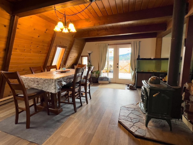 2063-A Marble Valley Basin Rd, Addy, WA 99101 - dining room featuring a wood stove, wood ceiling with exposed beams, a chandelier, wood finished floors, and french doors