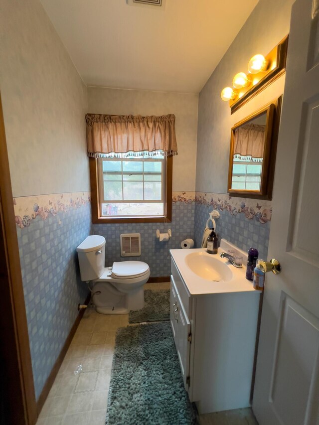 2063-A Marble Valley Basin Rd, Addy, WA 99101 - bathroom featuring toilet, a wainscoted wall, vanity, tile patterned flooring, and tile walls