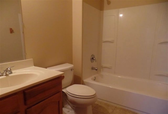 bathroom featuring toilet, tile patterned floors, vanity, and washtub / shower combination