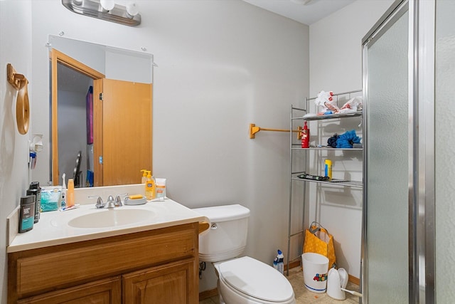 bathroom with toilet, tile patterned floors, and vanity