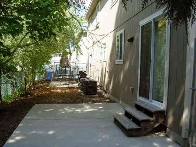 view of property exterior with central air condition unit, entry steps, a patio, and fence