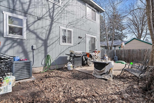 exterior space with fence and central AC unit