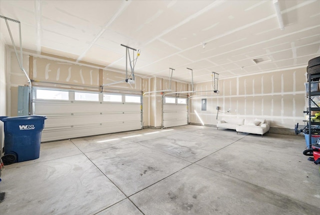 garage featuring a garage door opener and electric panel