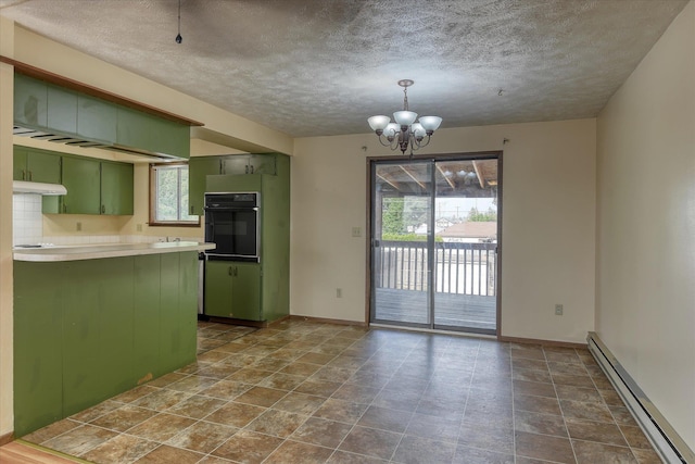 6208 N Wiscomb St, Spokane, WA 99208 - kitchen with green cabinetry, oven, baseboard heating, healthy amount of natural light, and a textured ceiling