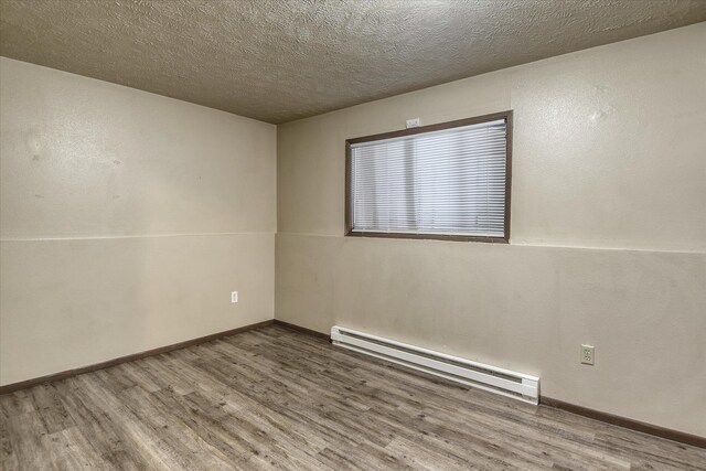 6208 N Wiscomb St, Spokane, WA 99208 - misc room with wood finished floors and a textured ceiling