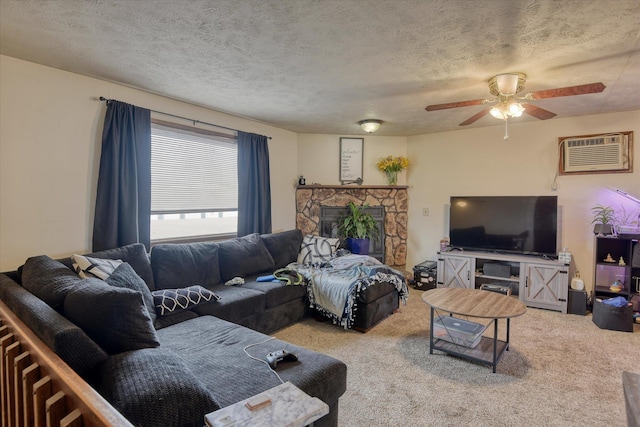 6208 N Wiscomb St, Spokane, WA 99208 - living area with an AC wall unit, carpet, a ceiling fan, a textured ceiling, and a stone fireplace