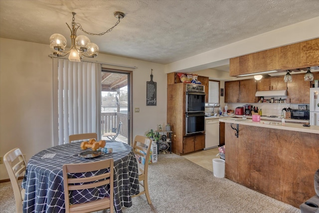 6208 N Wiscomb St, Spokane, WA 99208 - kitchen featuring black appliances, light countertops, light carpet, a chandelier, and a textured ceiling
