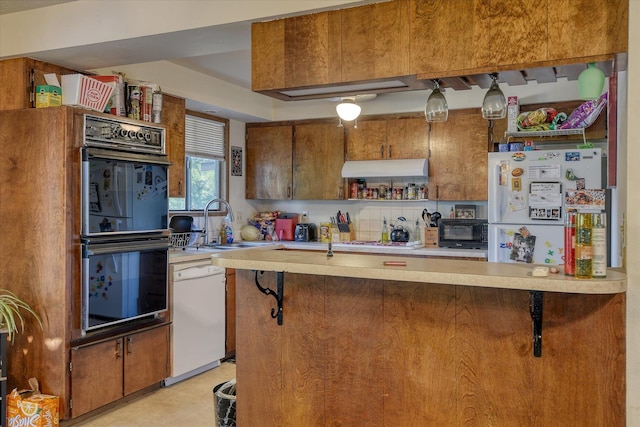 6208 N Wiscomb St, Spokane, WA 99208 - kitchen with white appliances, light countertops, brown cabinets, extractor fan, and open shelves